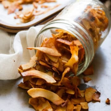 Jar of coconut bacon tipped over and spilling.