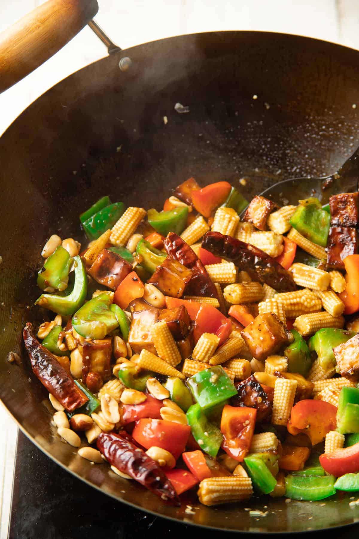 Kung Pao Tofu cooking in a skillet.
