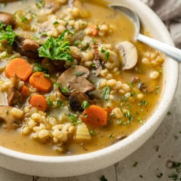 Close up of Mushroom Barley Soup in a bowl with spoon.