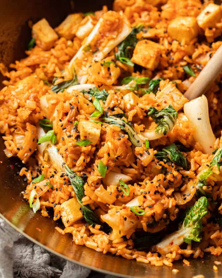 Close up of Vegan Kimchi Fried Rice in a wok with wooden spoon.