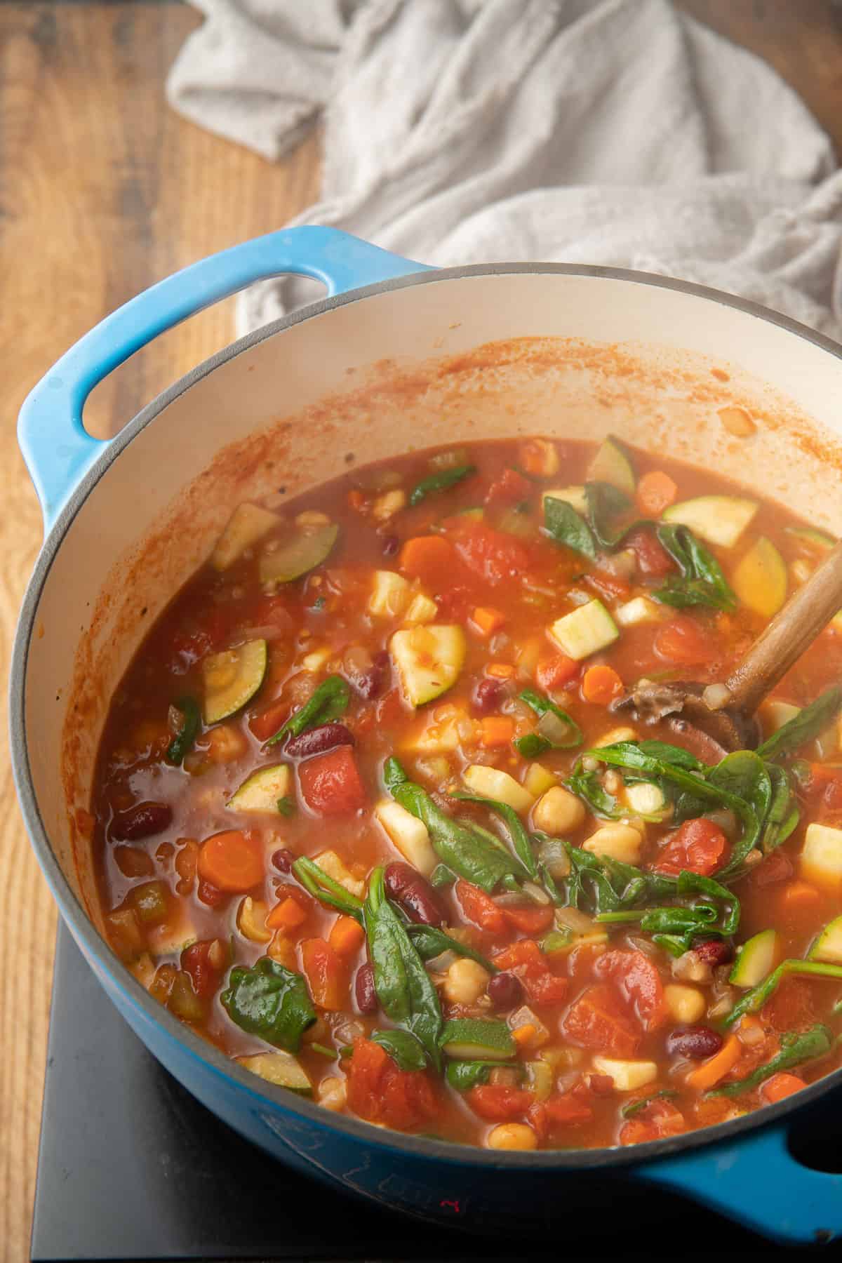 Vegan minestrone soup simmering in a pot.