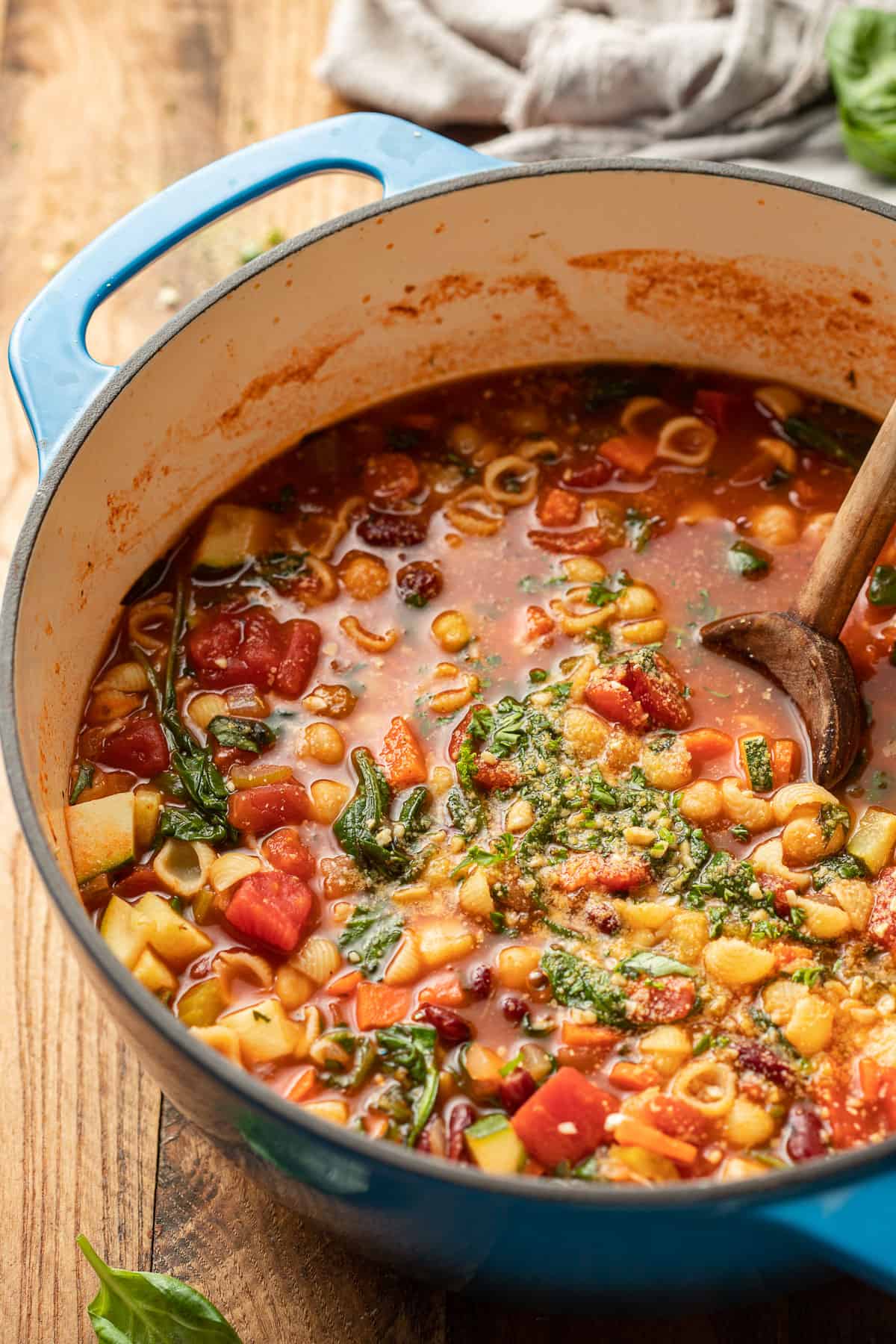 Pot of Vegan Minestrone Soup with a wooden spoon.
