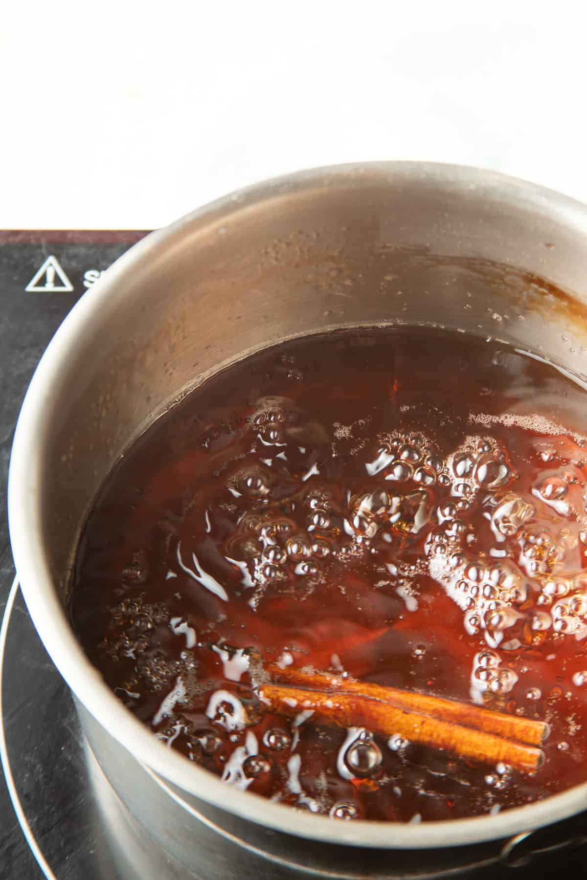 Baklava syrup simmering in a saucepan.