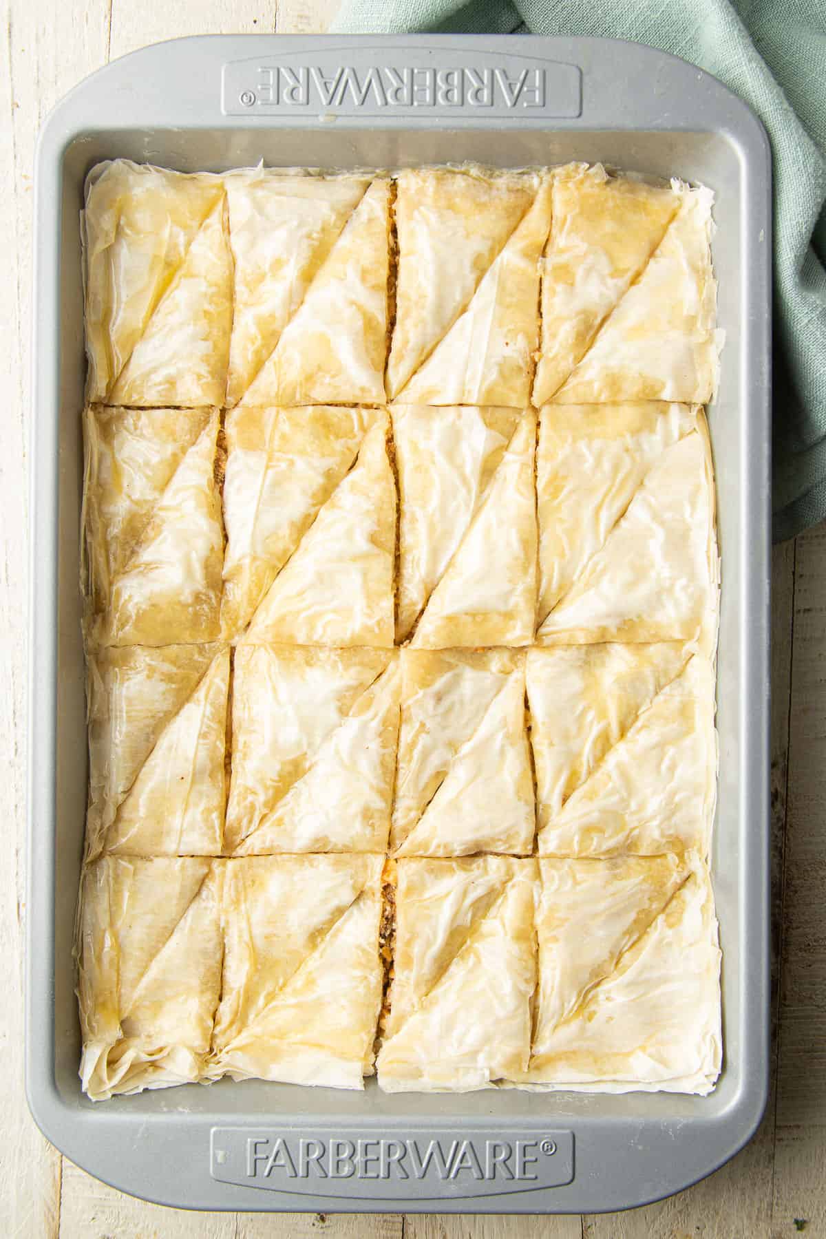 Unbaked and sliced Vegan Baklava in a baking pan.