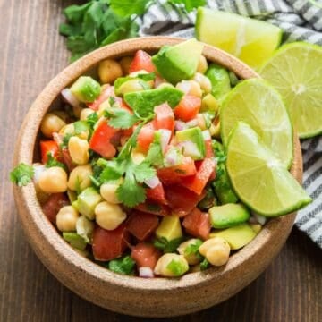 Bowl of vegan ceviche with lime wedges.