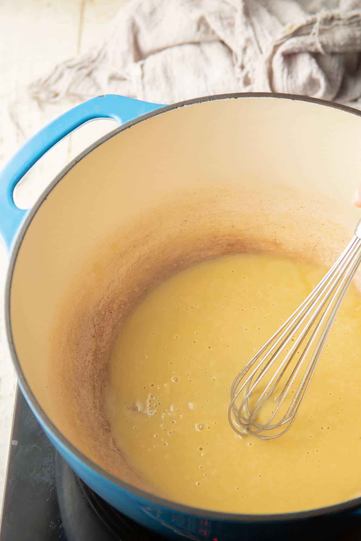 Cook the roux with the whisk in a pot.