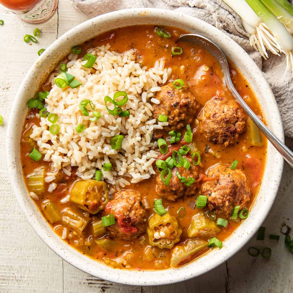 Bowl of Vegan Gumbo with rice and chopped scallions.
