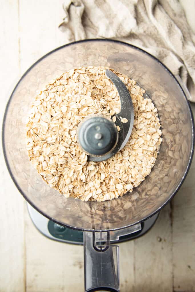 Rolled oats in a food processor bowl.
