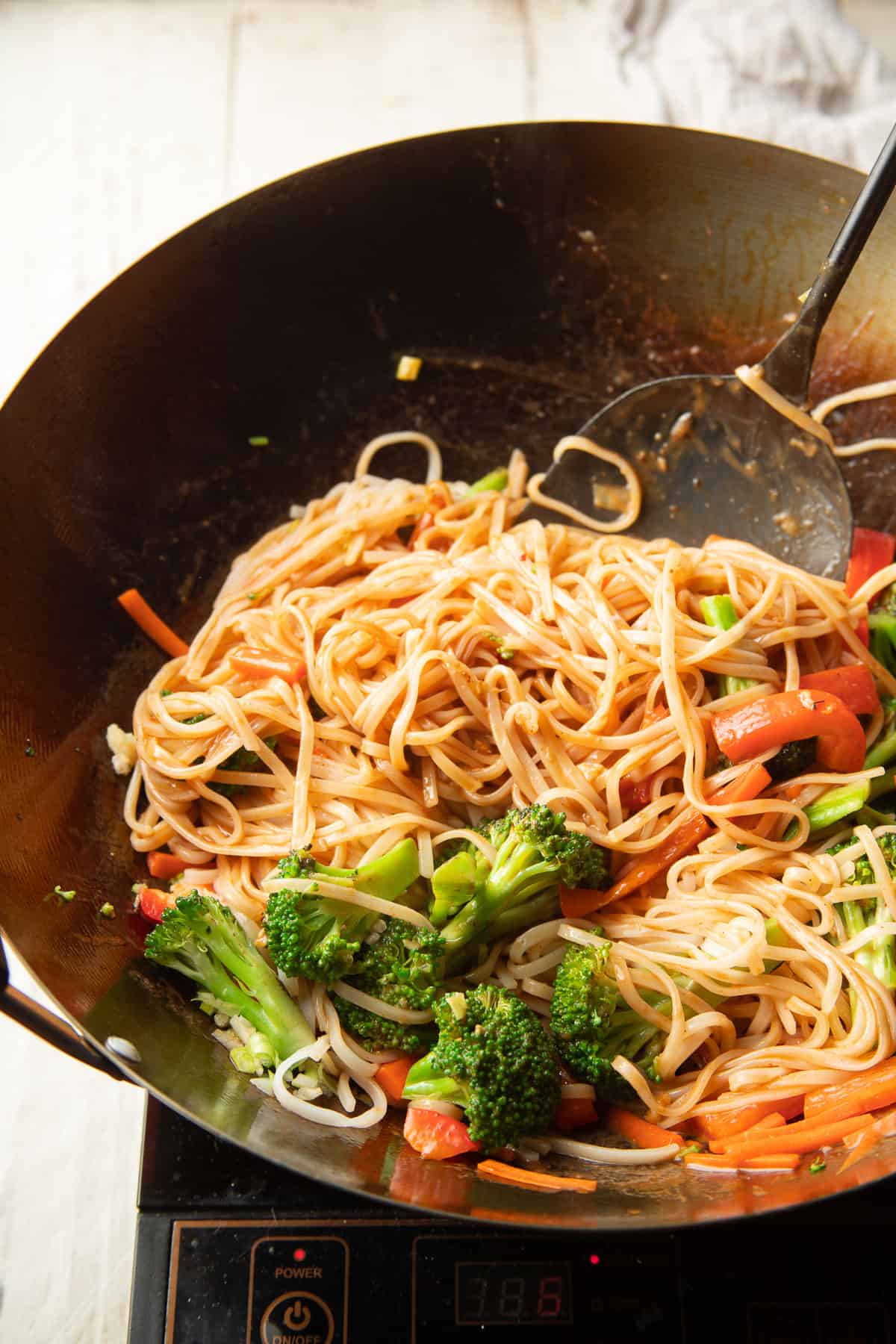 Hoisin Noodles and vegetables cooking in a wok.