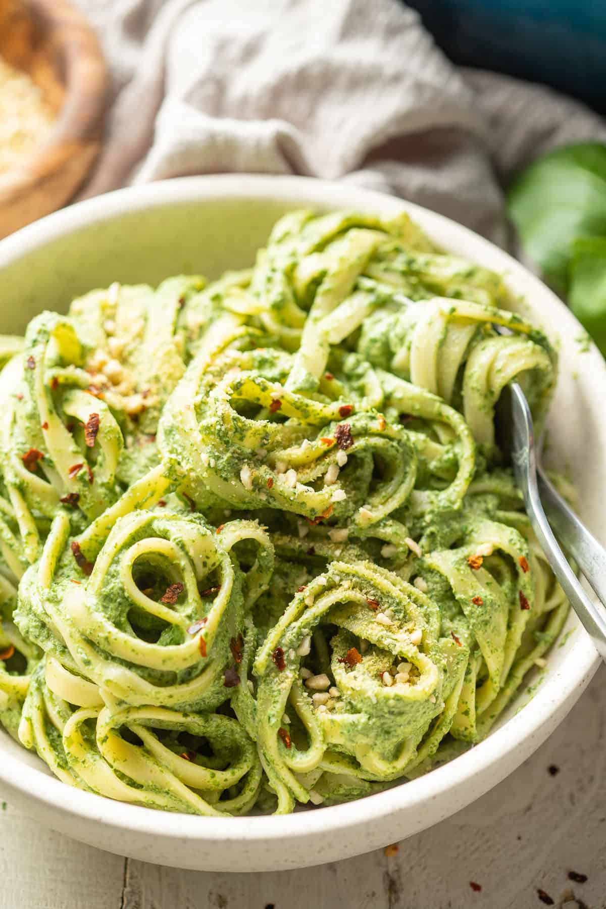 Close up of vegan spinach pasta in a bowl.
