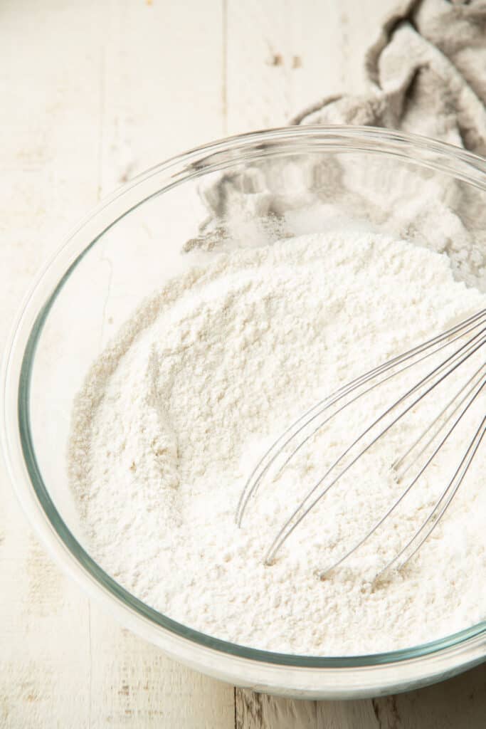 Bowl of dry ingredients for shortcake with a whisk.