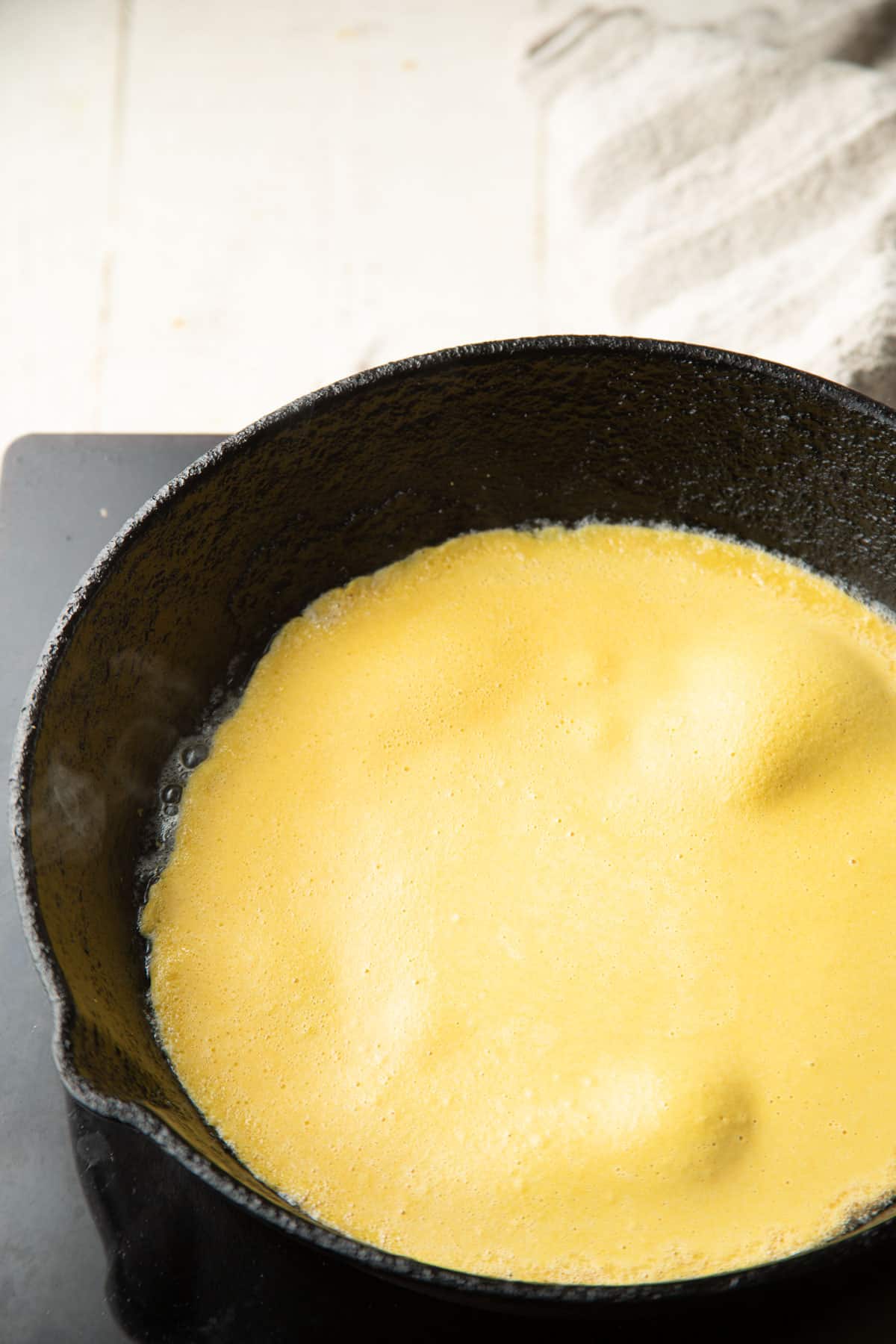 Chickpea flour batter in a pan.