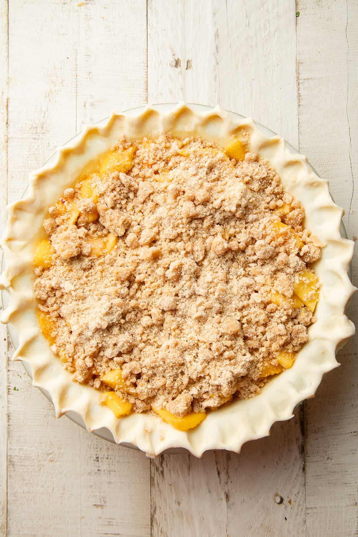 Unbaked Vegan Peach Pie with crumble topping.
