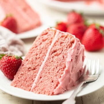 Slice of Vegan Strawberry Cake on a dish with fork.
