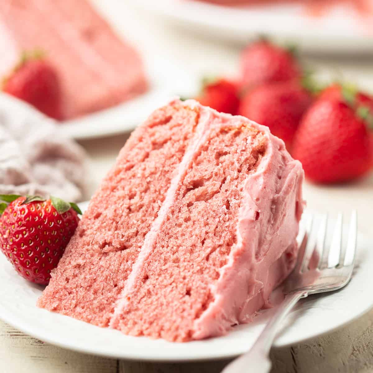 Slice of Vegan Strawberry Cake on a dish with fork.