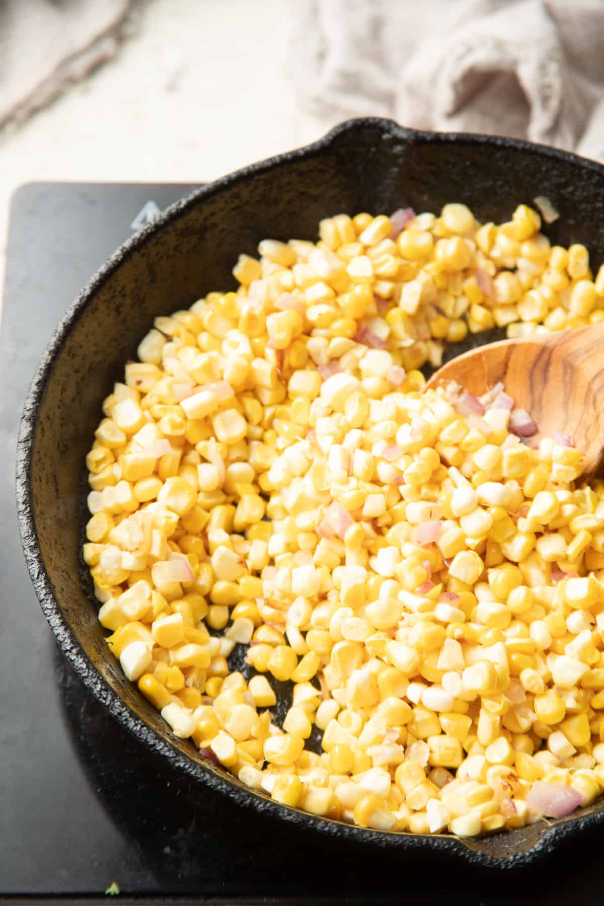 Corn cooking in a skillet.