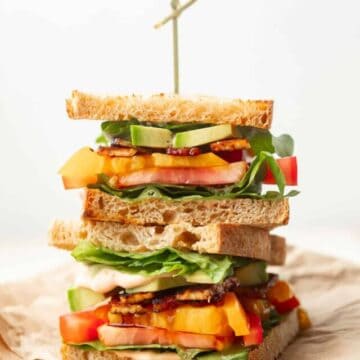 Two stacked halves of a Vegan BLT Sandwich.