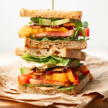 Two stacked halves of a Vegan BLT Sandwich.