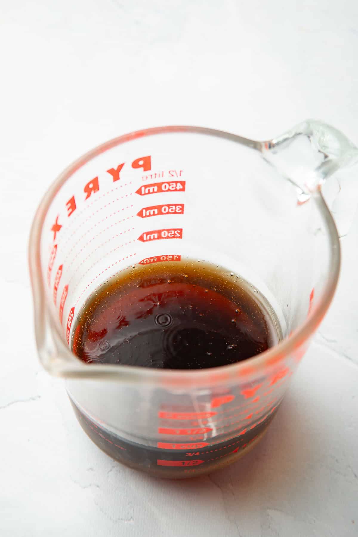 Cola in a liquid measuring cup.
