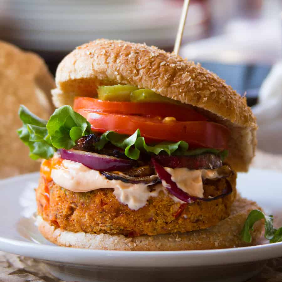 Black eyed pea burger topped with vegan remoulade, onion, lettuce, tomato and pickles.