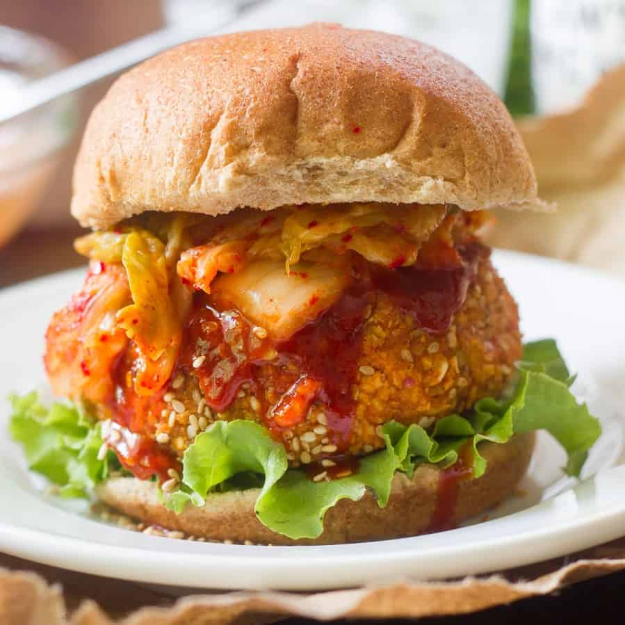 Korean tofu burger topped with spicy sauce and kimchi.