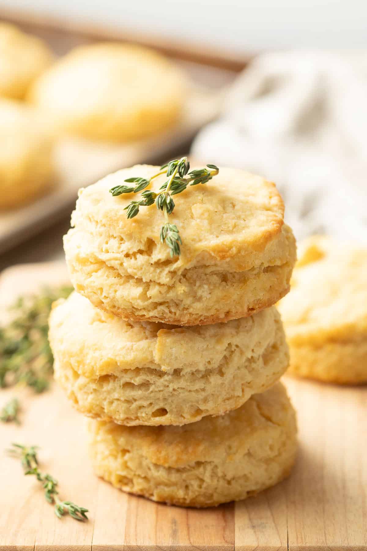 Stack of three Vegan Biscuits with sprigs of fresh thyme on top.