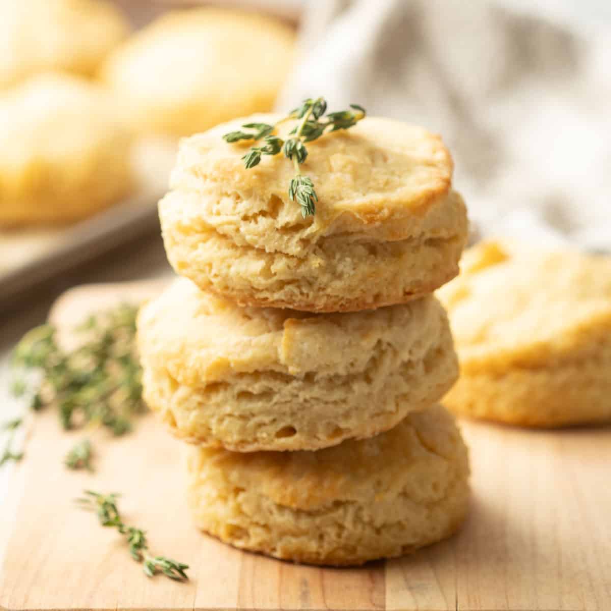 Stack of three Vegan Biscuits with sprigs of fresh thyme on top.