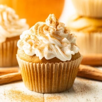 Vegan Pumpkin Cupcake with cream cheese frosting and cinnamon on top.