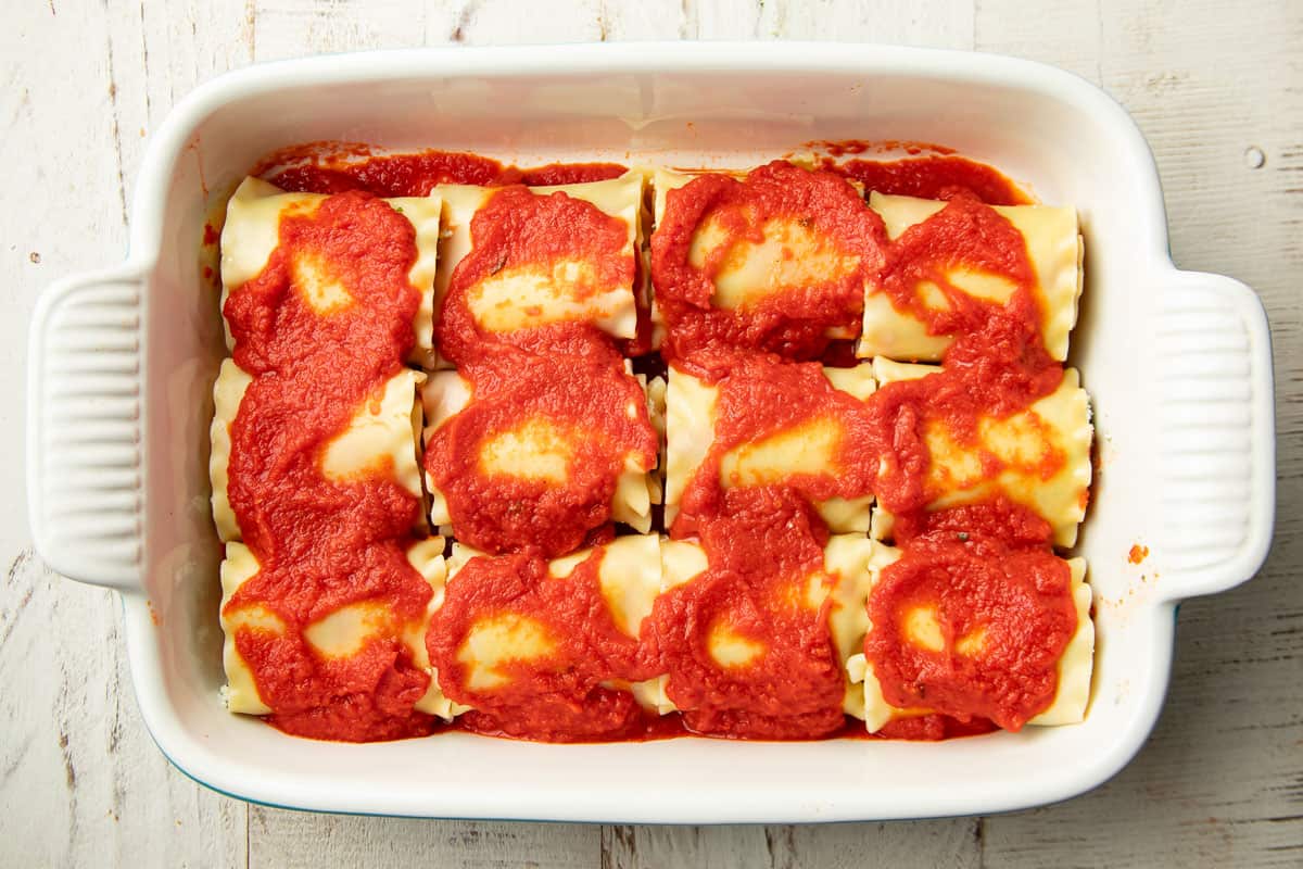 Uncooked Vegan Lasagna Roll-Ups in a baking dish.