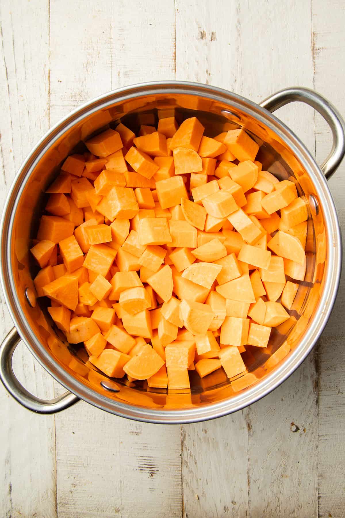 Diced sweet potatoes in a pot of water.