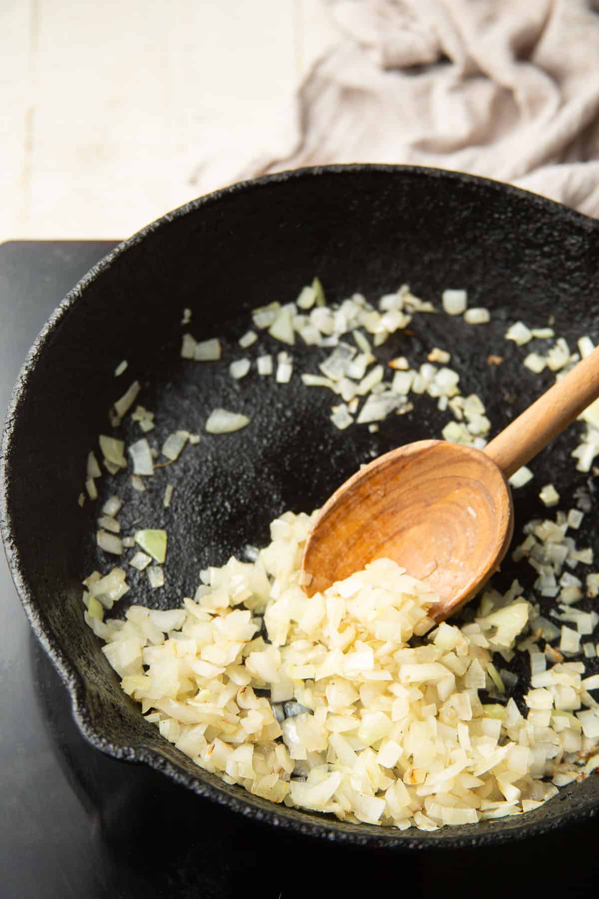Diced onion cooking in a skillet.