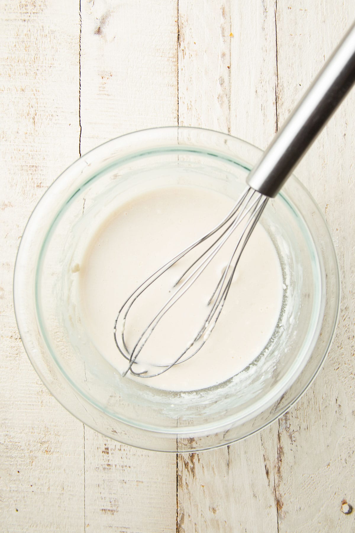 Bowl filled with batter with a whisk.