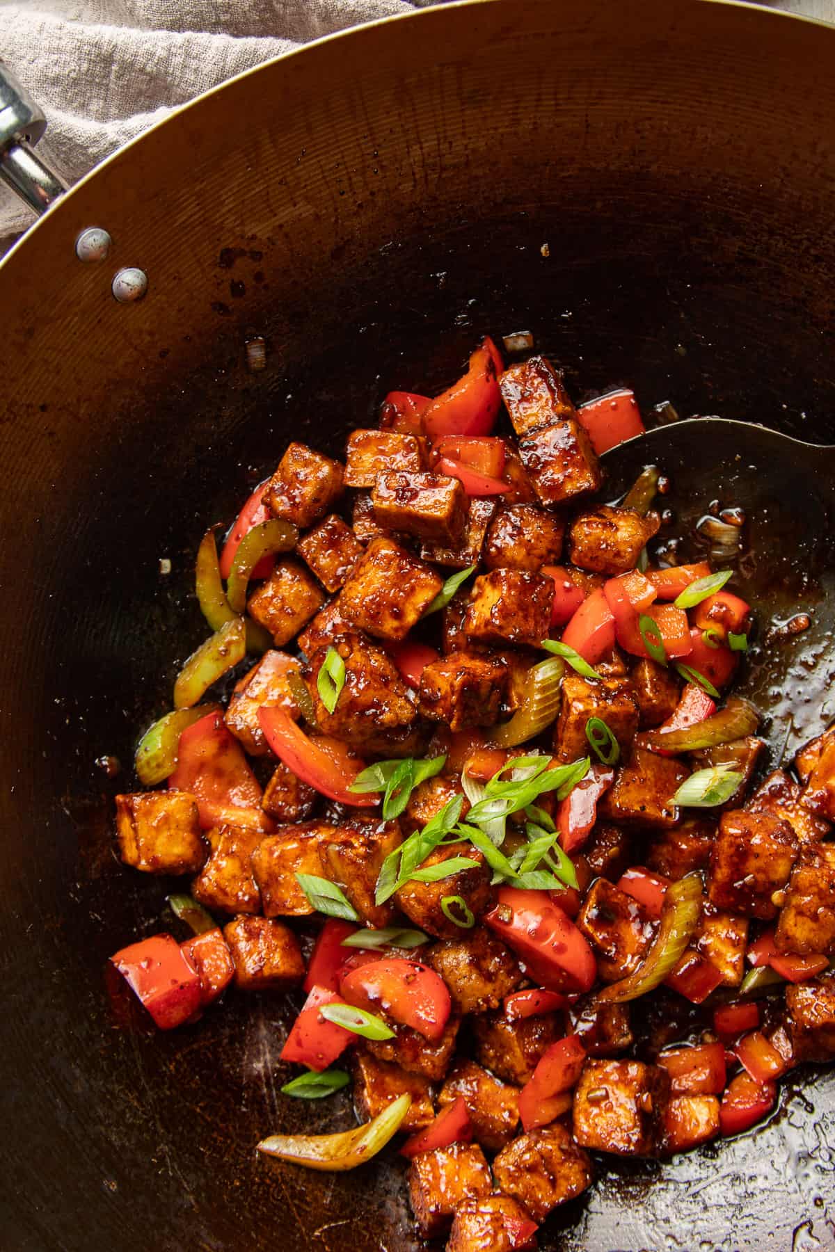 Black Pepper Tofu and vegetables in a wok.