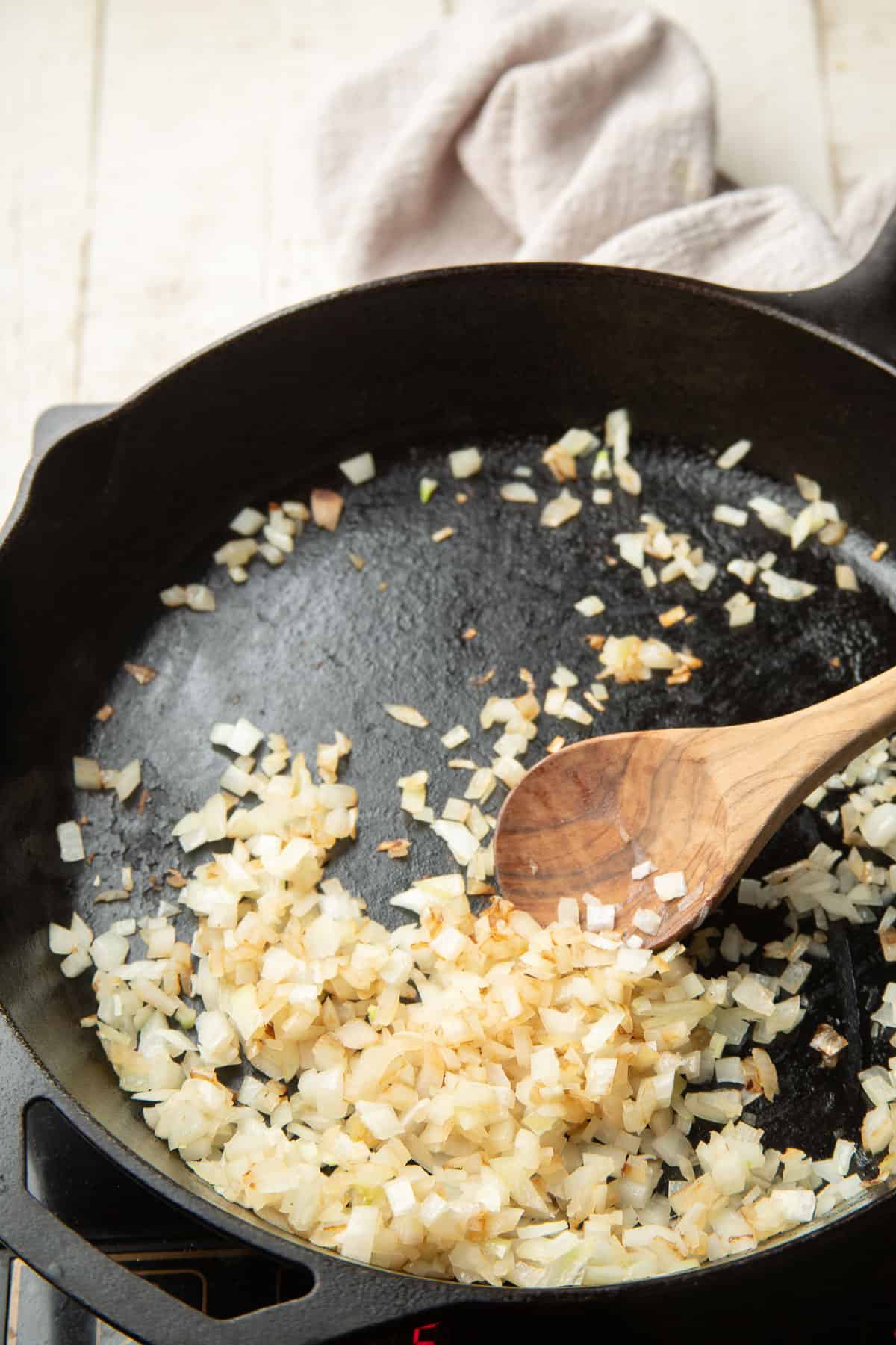 Diced onion cooking in a skillet.