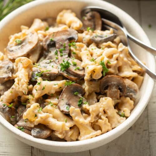 Bowl of Vegan Mushroom Stroganoff with a fork and spoon.