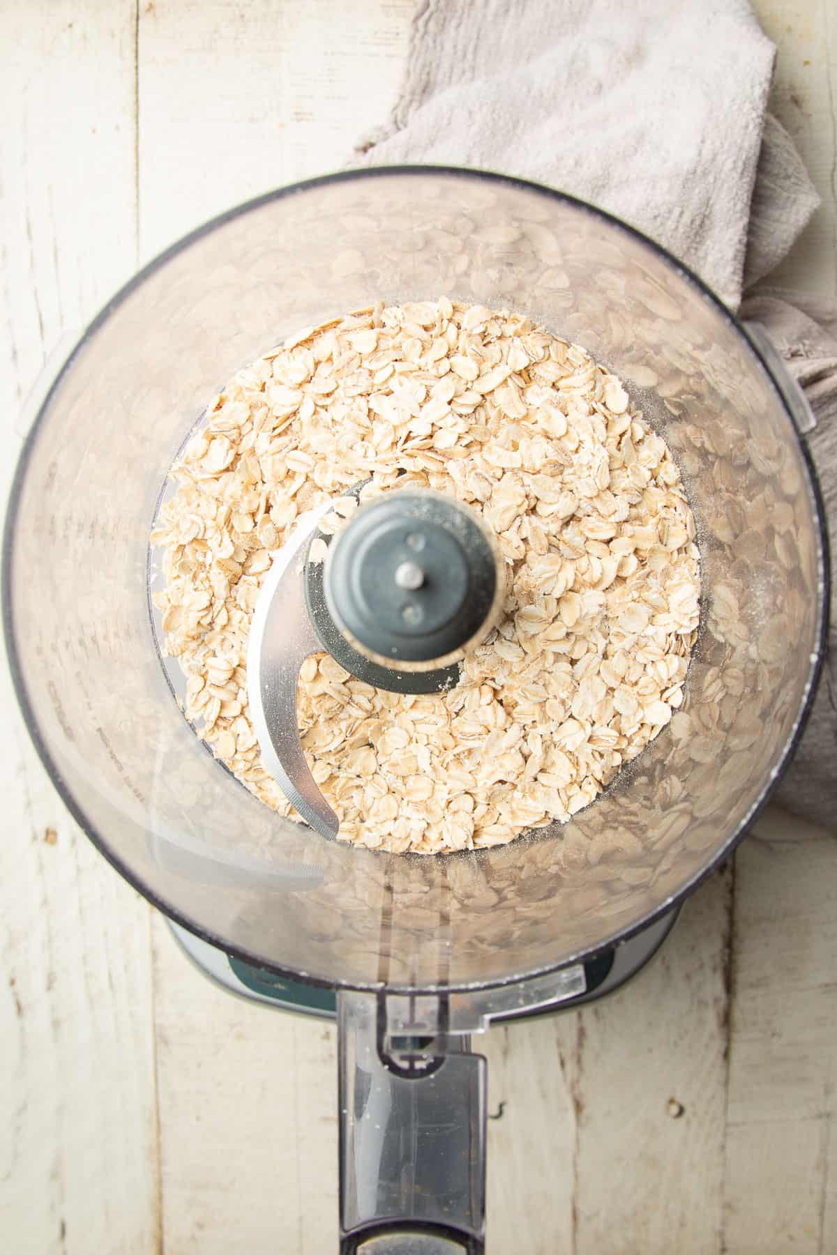 Whole oats in a food processor bowl.