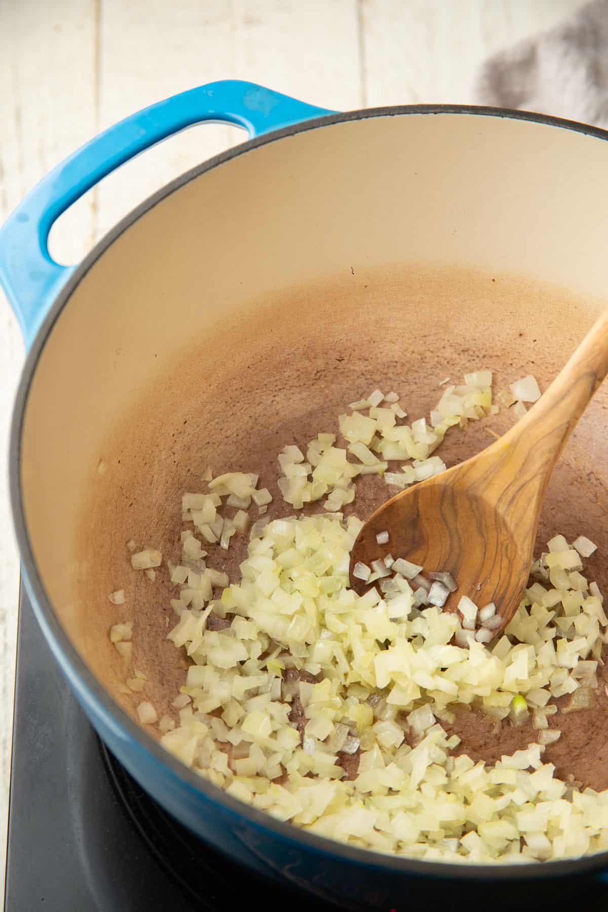 Diced onions cooking in a pot.