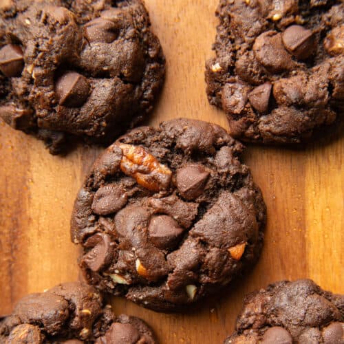 Vegan chocolate cookies on a wooden surface.