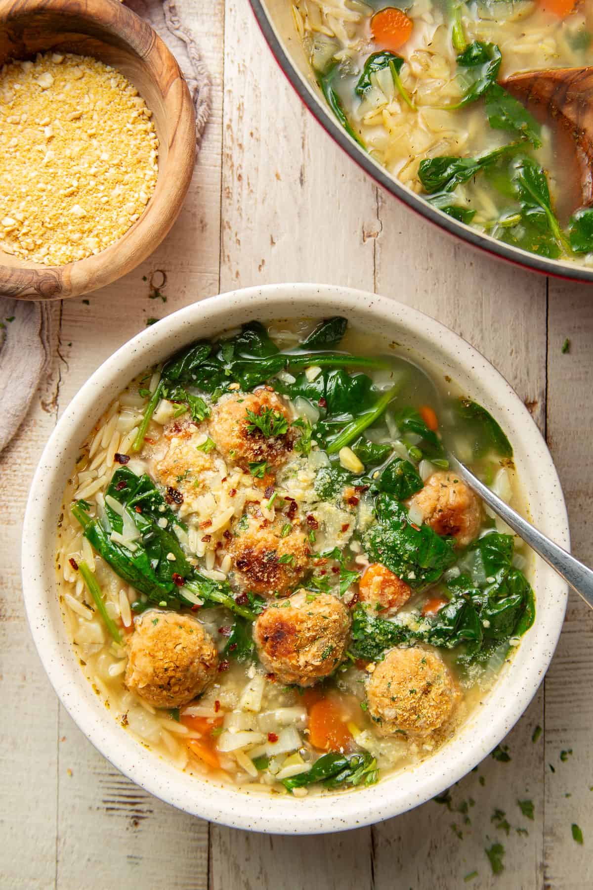 This vegan Italian wedding soup is delicious, comforting, and full of flavor! Made with hearty cannellini bean "meatballs," tender orzo, fennel and spinach, it's packed with vibrant flavors and perfect for cozying up with on a chilly day.