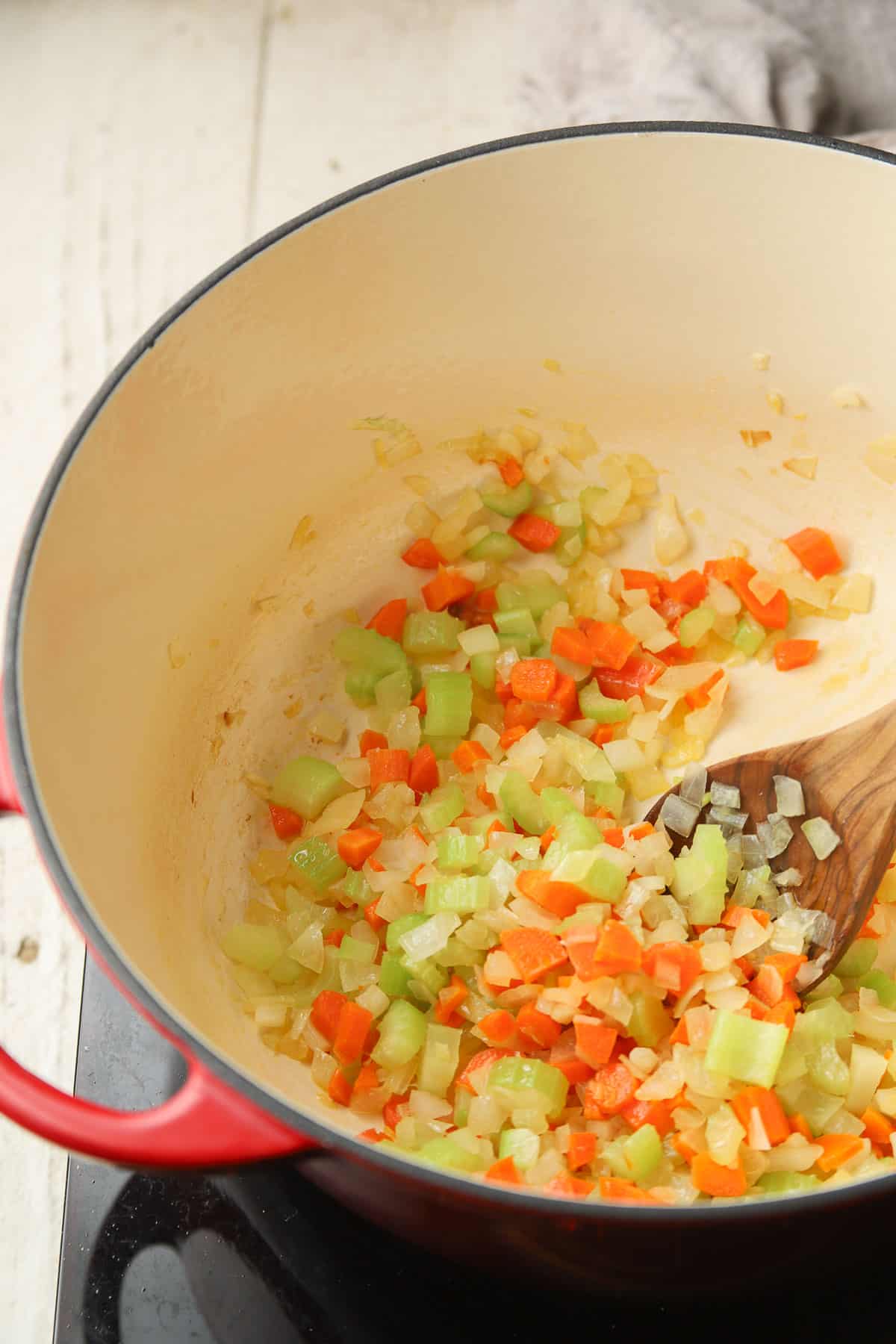 Carrots, onion, celery and garlic cooking in a pot.