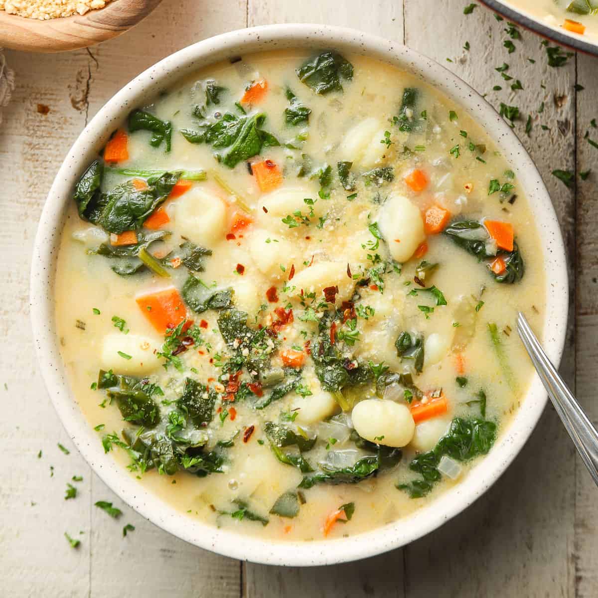 Bowl of Vegan Gnocchi Soup with spoon.