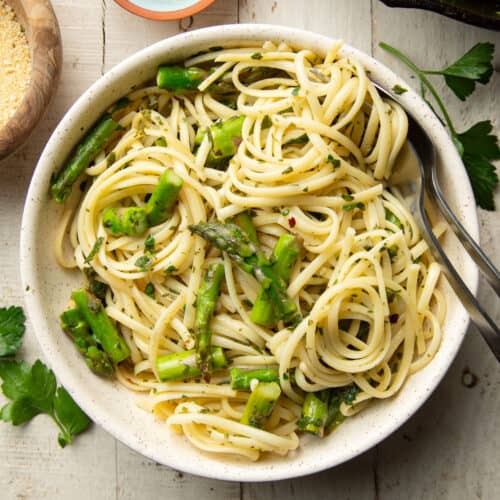 Bowl of pasta and asparagus with gremolata sauce.
