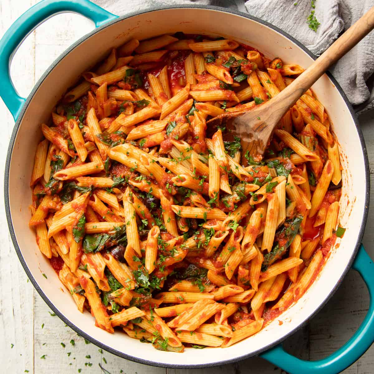 Pot of Swiss Chard Pasta with a wooden spoon.