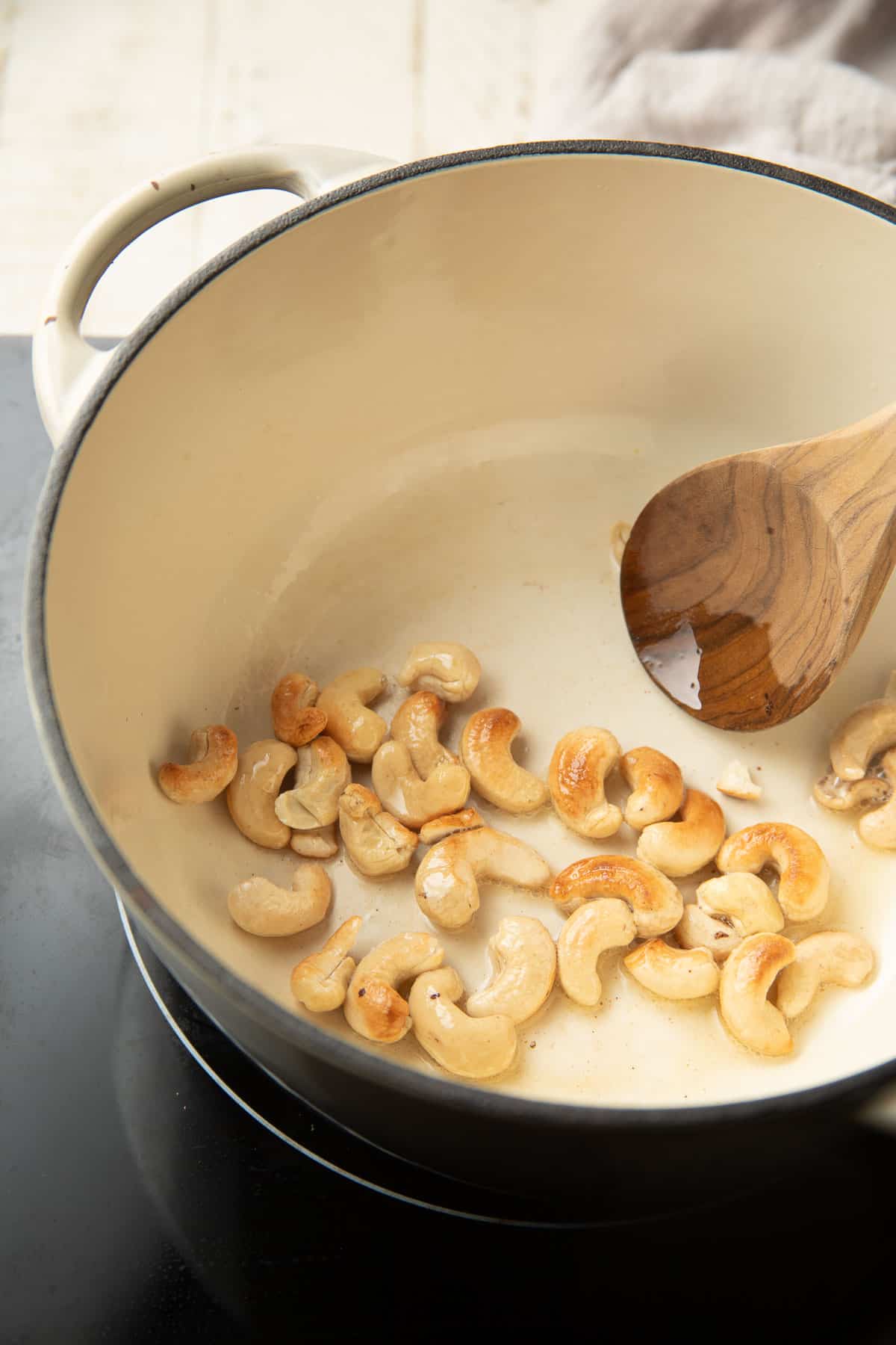 Cashews cooking in a pot.