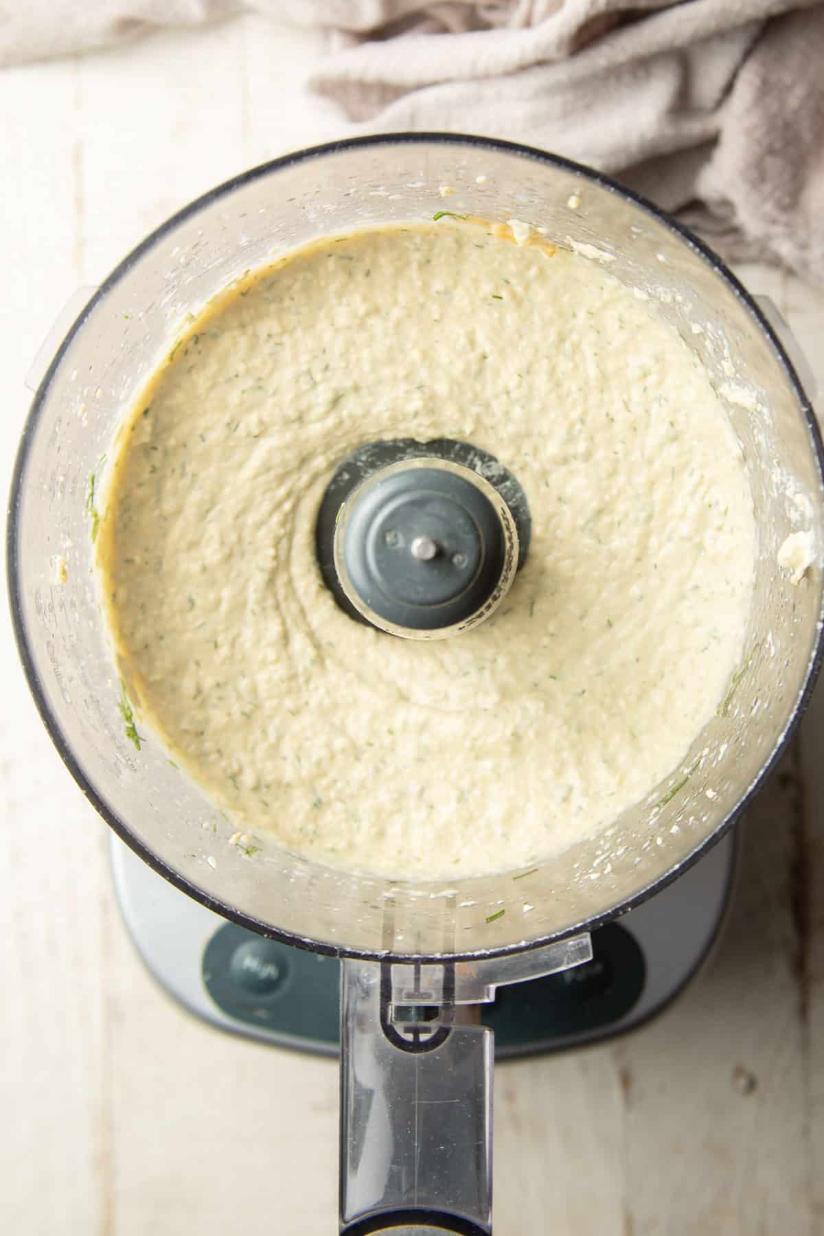 Dill Pickle Hummus in a food processor bowl, just after being blended,