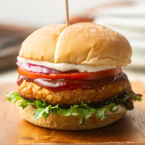 Tofu Burger topped with lettuce, tomato, onion, barbecue sauce, and mayonnaise.