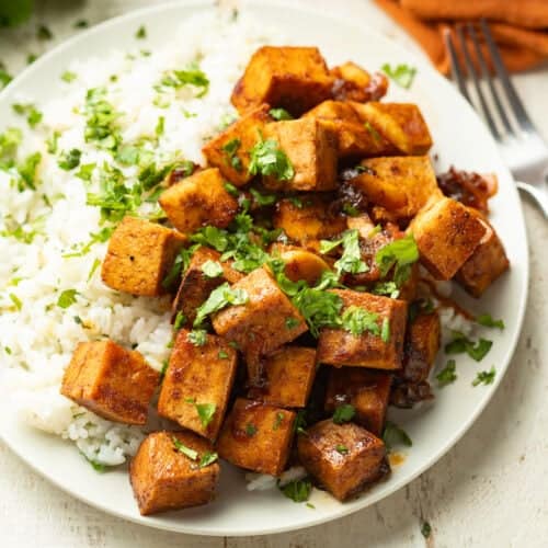 Plate of Chili Lime Tofu and coconut lime rice with a fork.
