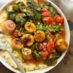 Bowl of Vegan Scallops & Grits topped with chives.