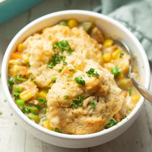 Bowl of Vegan Chicken & Biscuits Casserole with spoon.