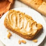 Slice of Peanut Butter Bread topped with peanut butter.